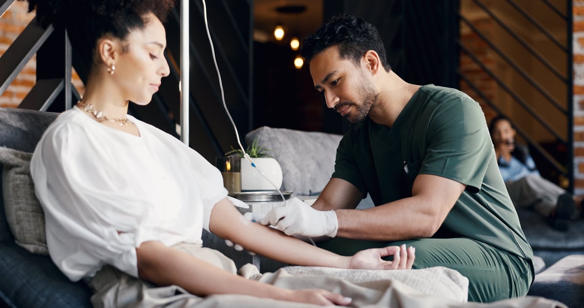 Patient receiving IV therapy in a comfortable wellness center lounge setting